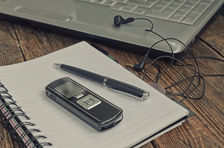 recorder and notebook with laptop